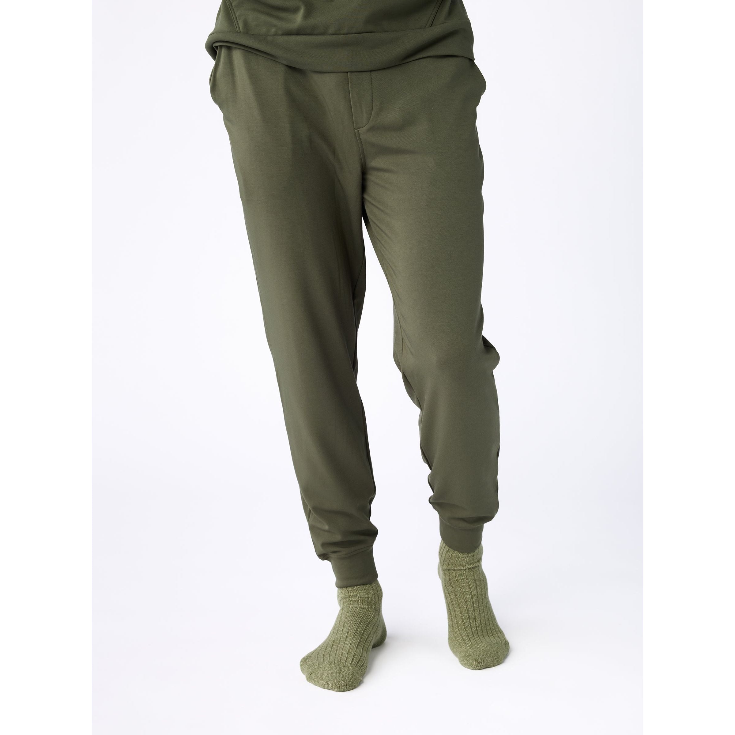 Green jogger pants and socks on a white background