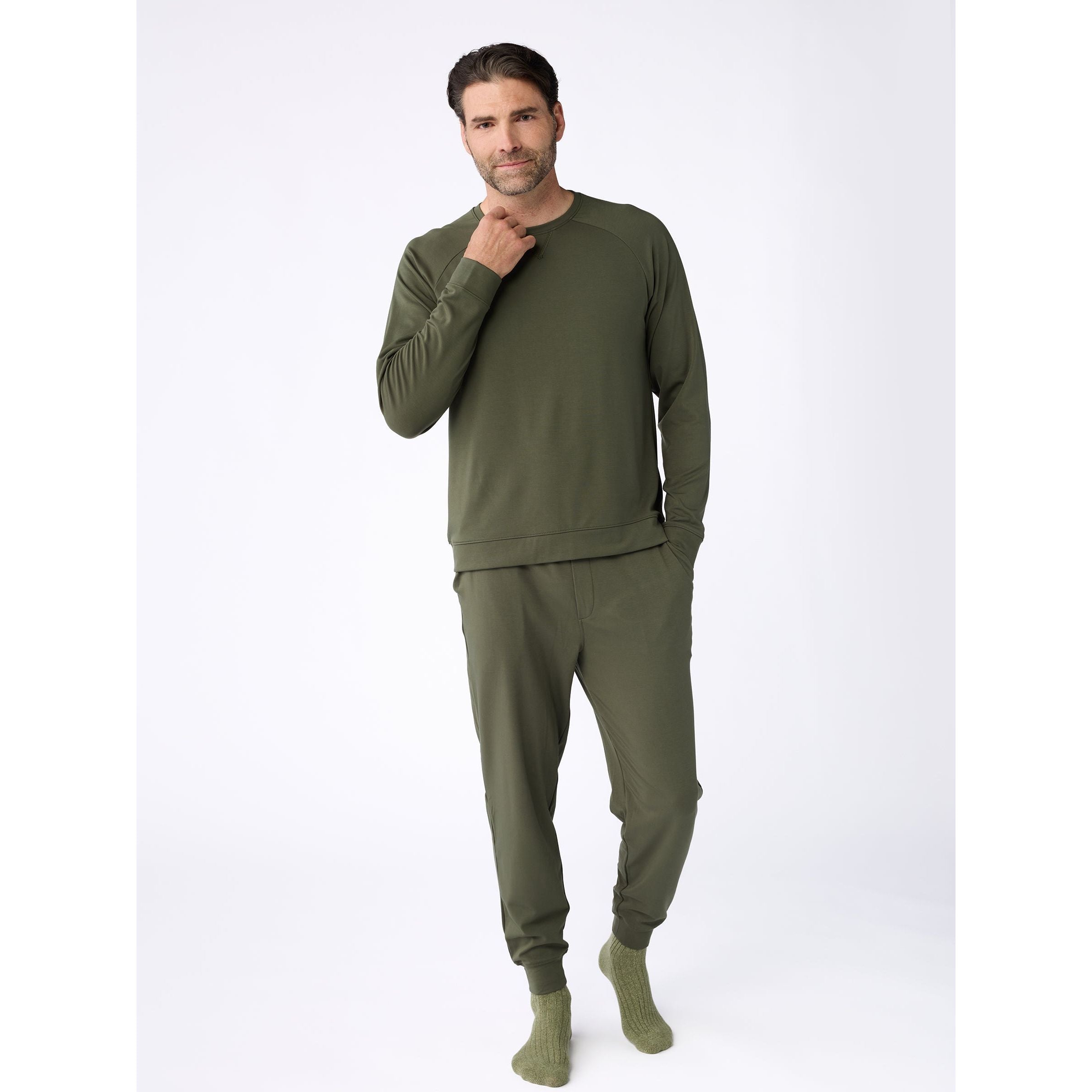 Man wearing a green loungewear set on a white background