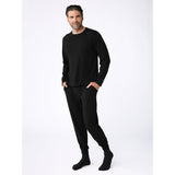 Man wearing a black outfit on a white background