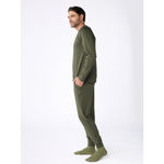 Man wearing a green pajama set on a white background