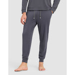 Person wearing gray sweatpants on a light gray background