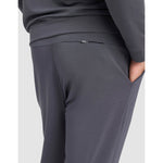 Gray sweatpants worn by a person on a light gray background