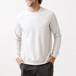 Man wearing a light gray sweatshirt on a white background