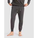 Person wearing gray sweatpants on a white background