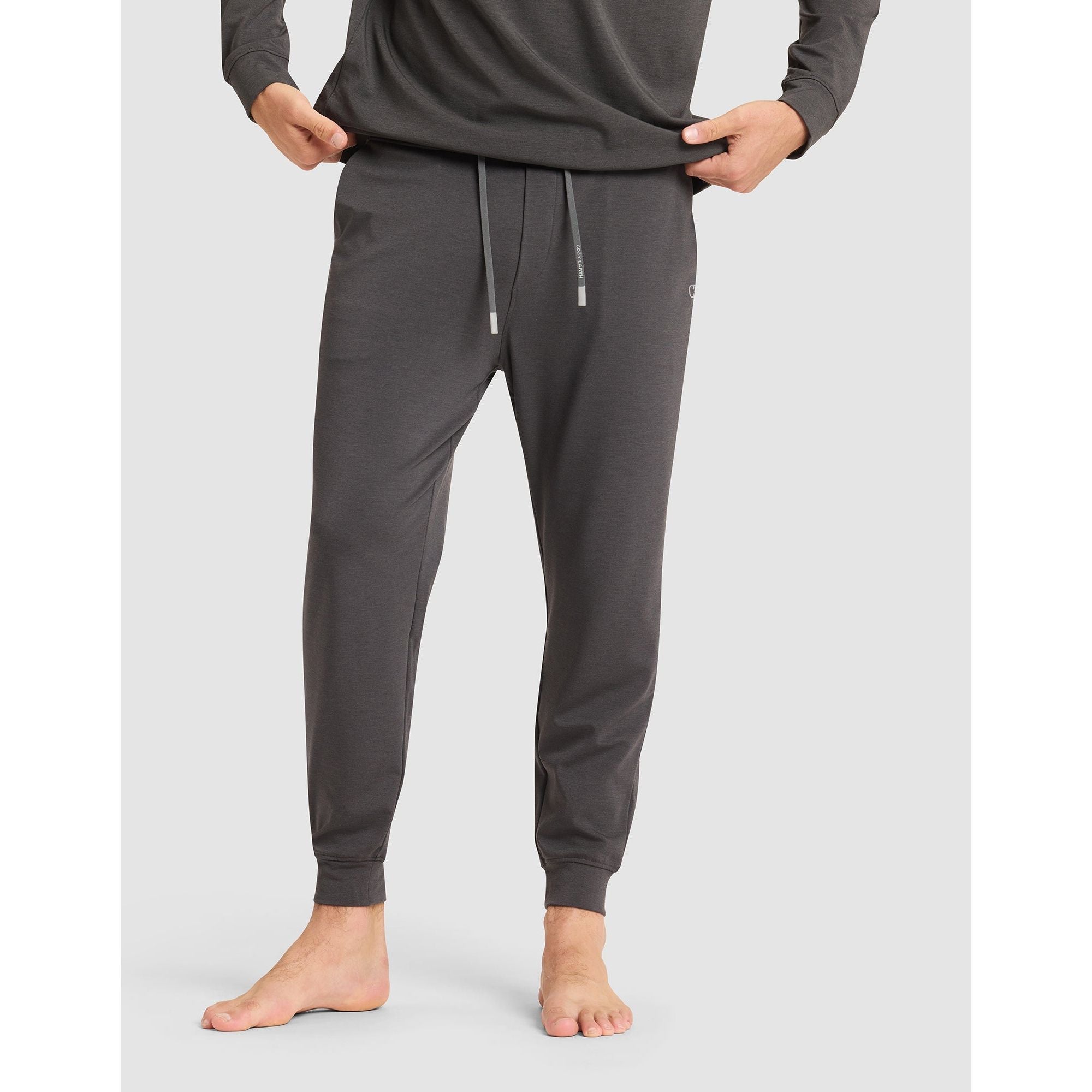 Person wearing gray sweatpants on a white background