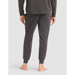 Person wearing gray sweatpants on a light gray background