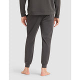 Person wearing gray sweatpants on a light gray background
