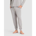 Gray sweatpants worn by a person on a light gray background