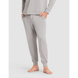 Gray sweatpants worn by a person on a light gray background