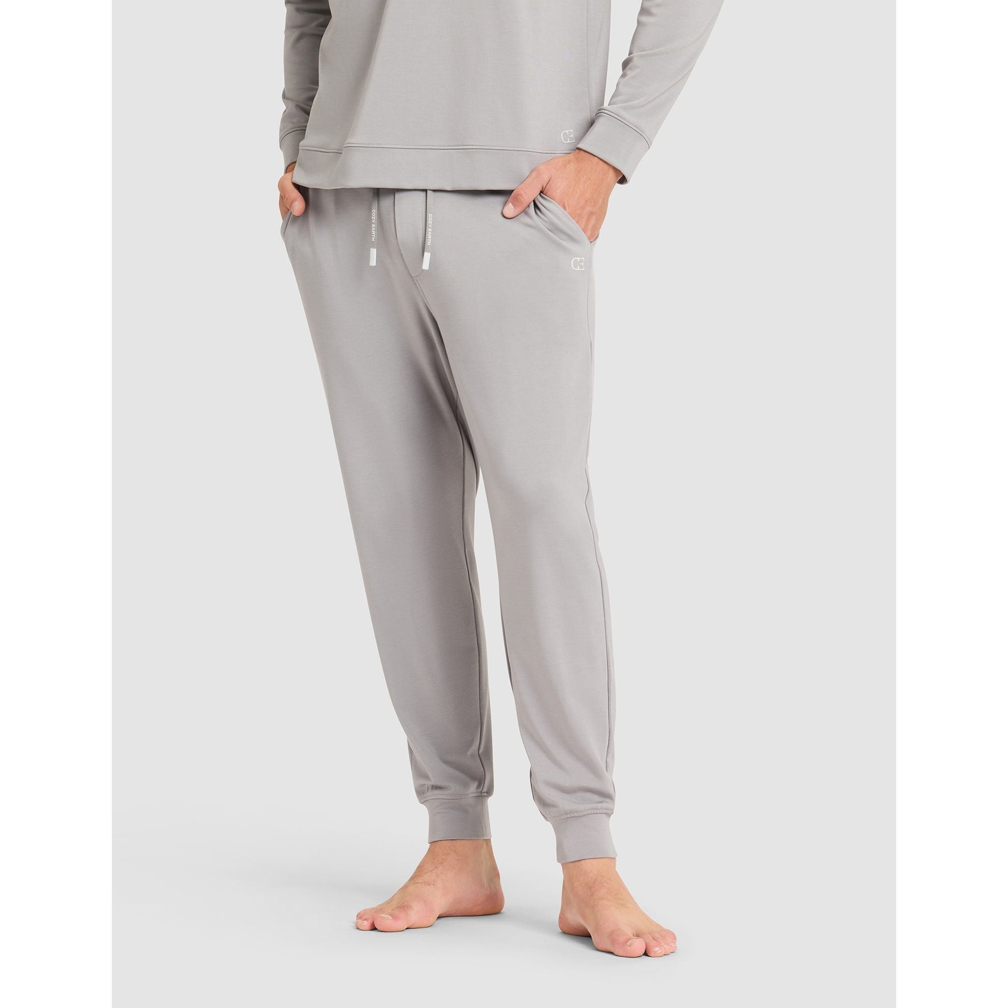 Gray sweatpants worn by a person on a light gray background