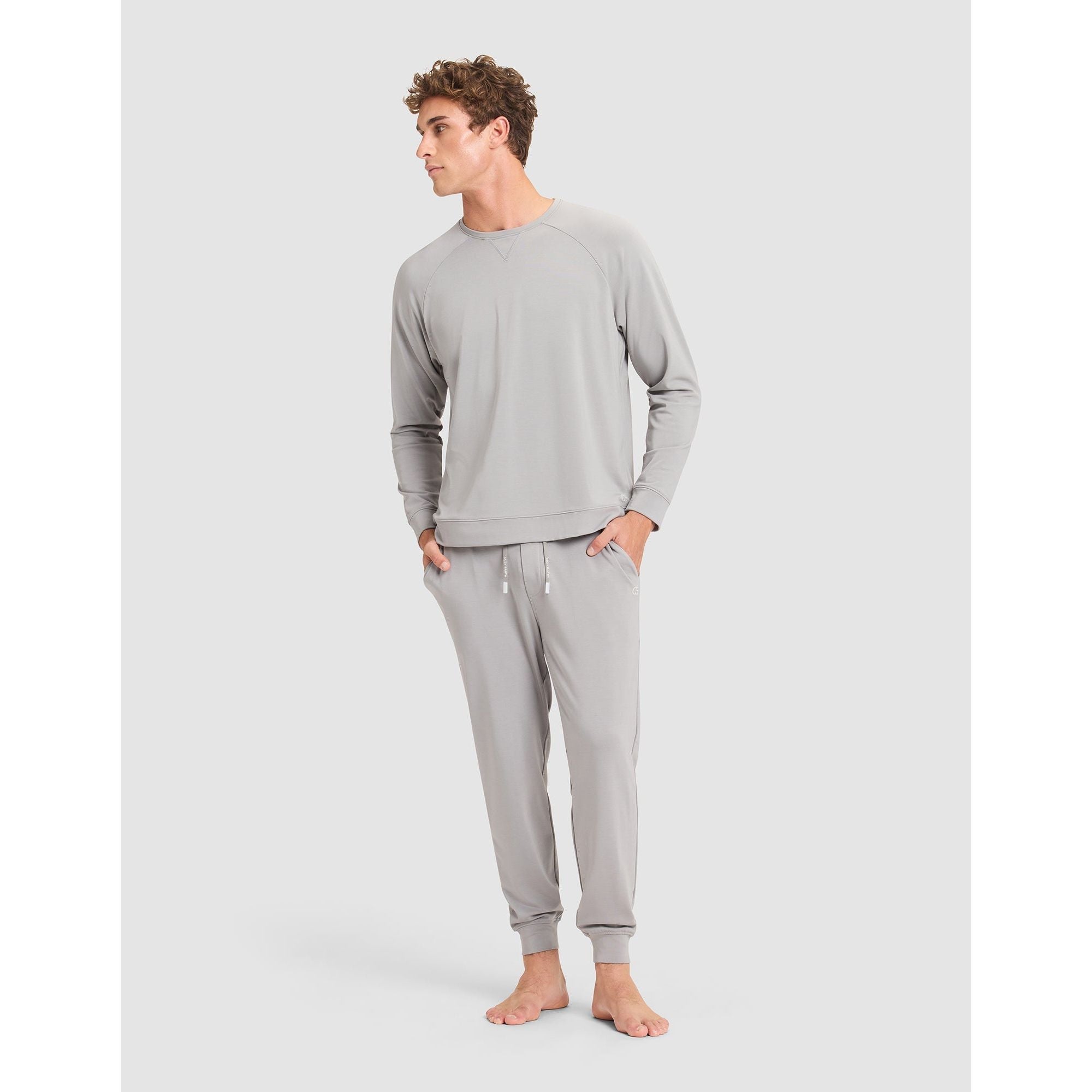 Man wearing a gray loungewear set on a white background