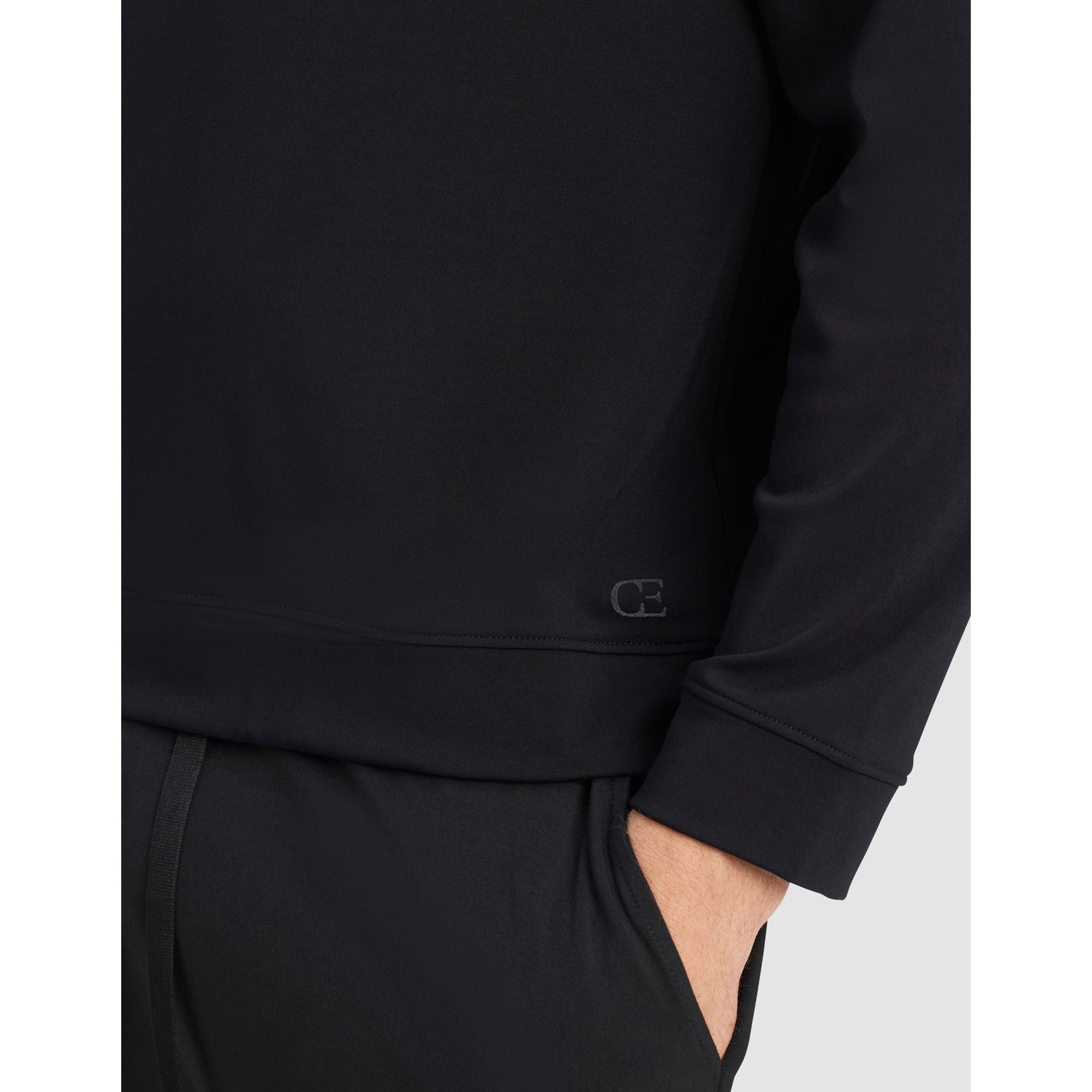 Black sweatshirt with a logo on the sleeve against a white background