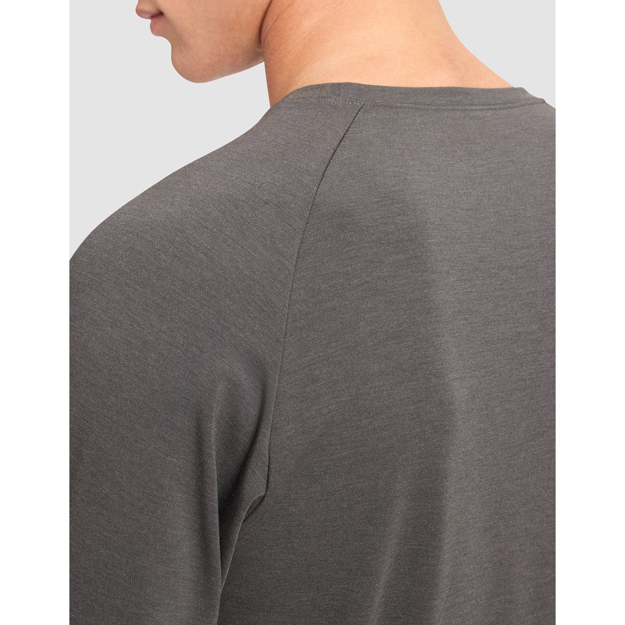 Gray long-sleeve shirt worn by a person on a light gray background