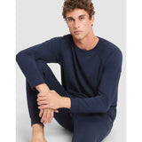 Man wearing a navy blue long-sleeve shirt and pants on a light gray background