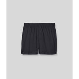Black silk boxer shorts flat lay on gray background