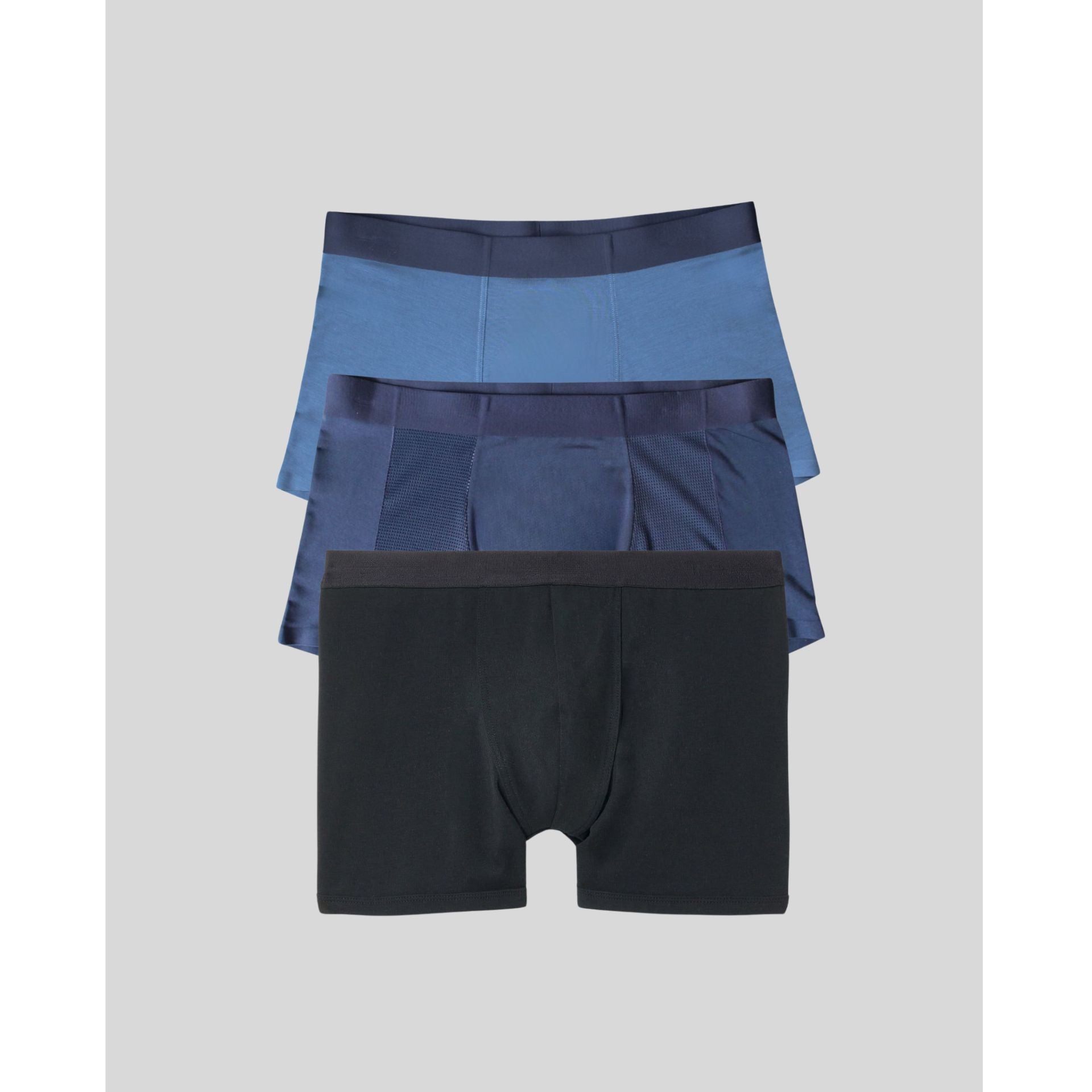 Three pairs of men's underwear in blue and black on a light gray background