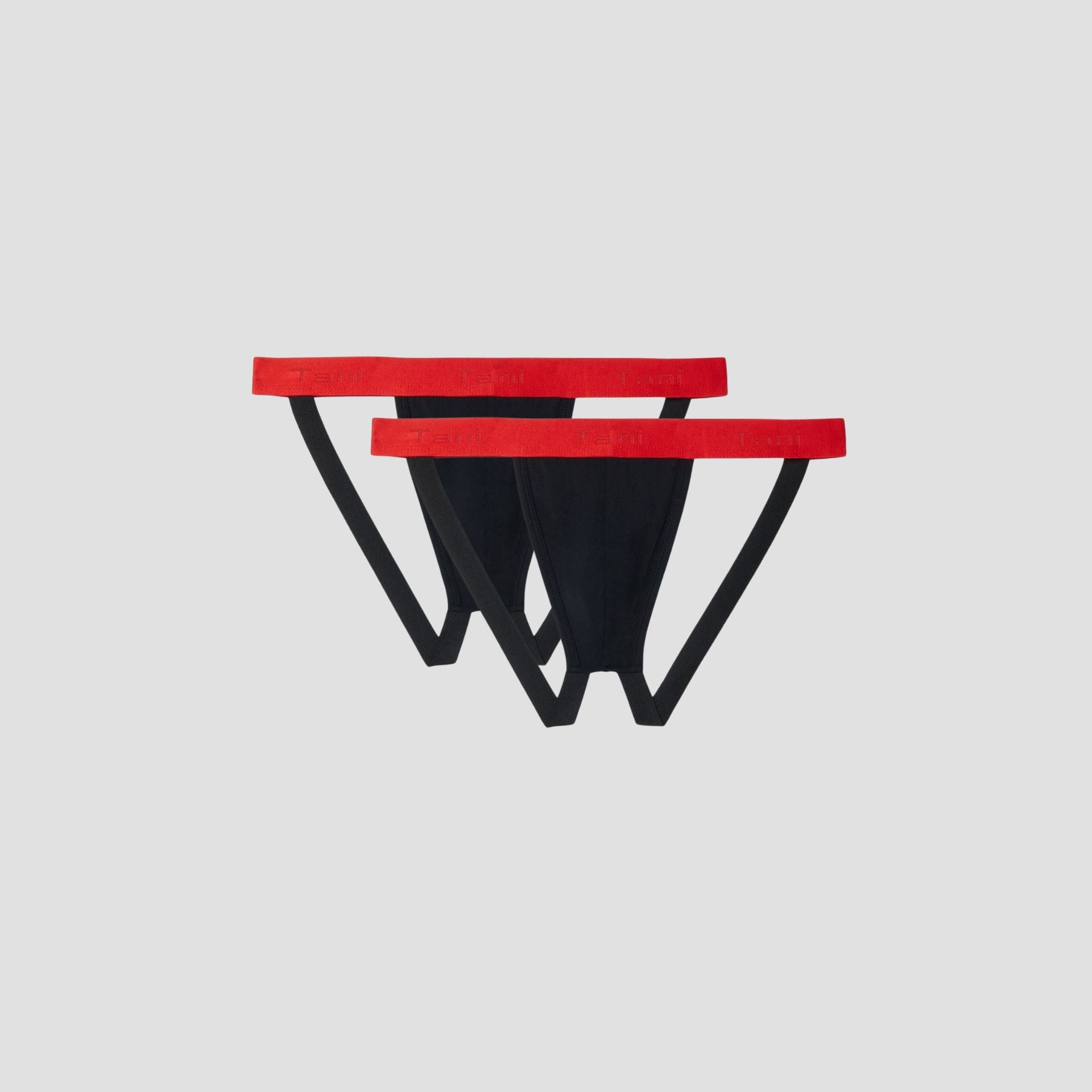 SilkCut black jockstrap with red waistband folded flat on white background
