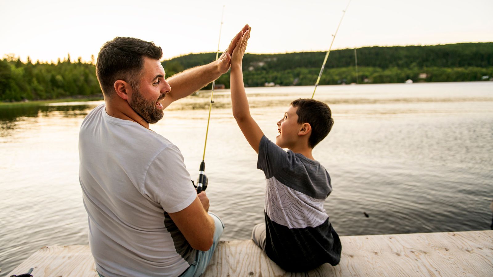A stylish dad over 50 lounging comfortably in SilkCut boxer briefs and a V-neck undershirt.