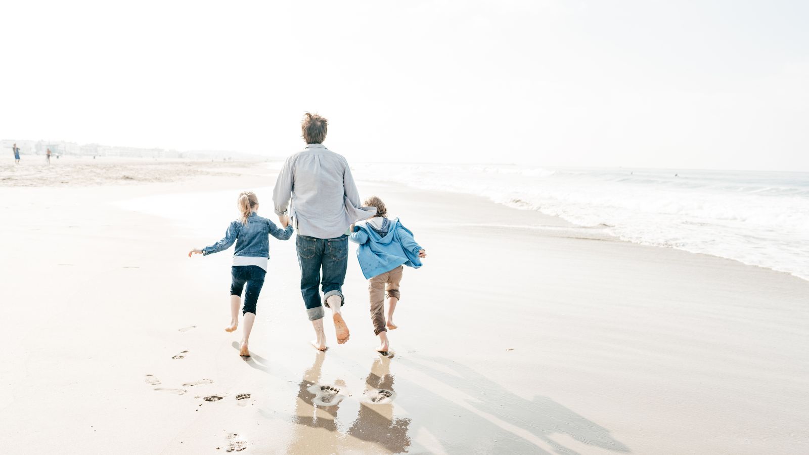 Dad smiling while holding a wrapped pair of SilkCut boxer briefs on Father’s Day morning.