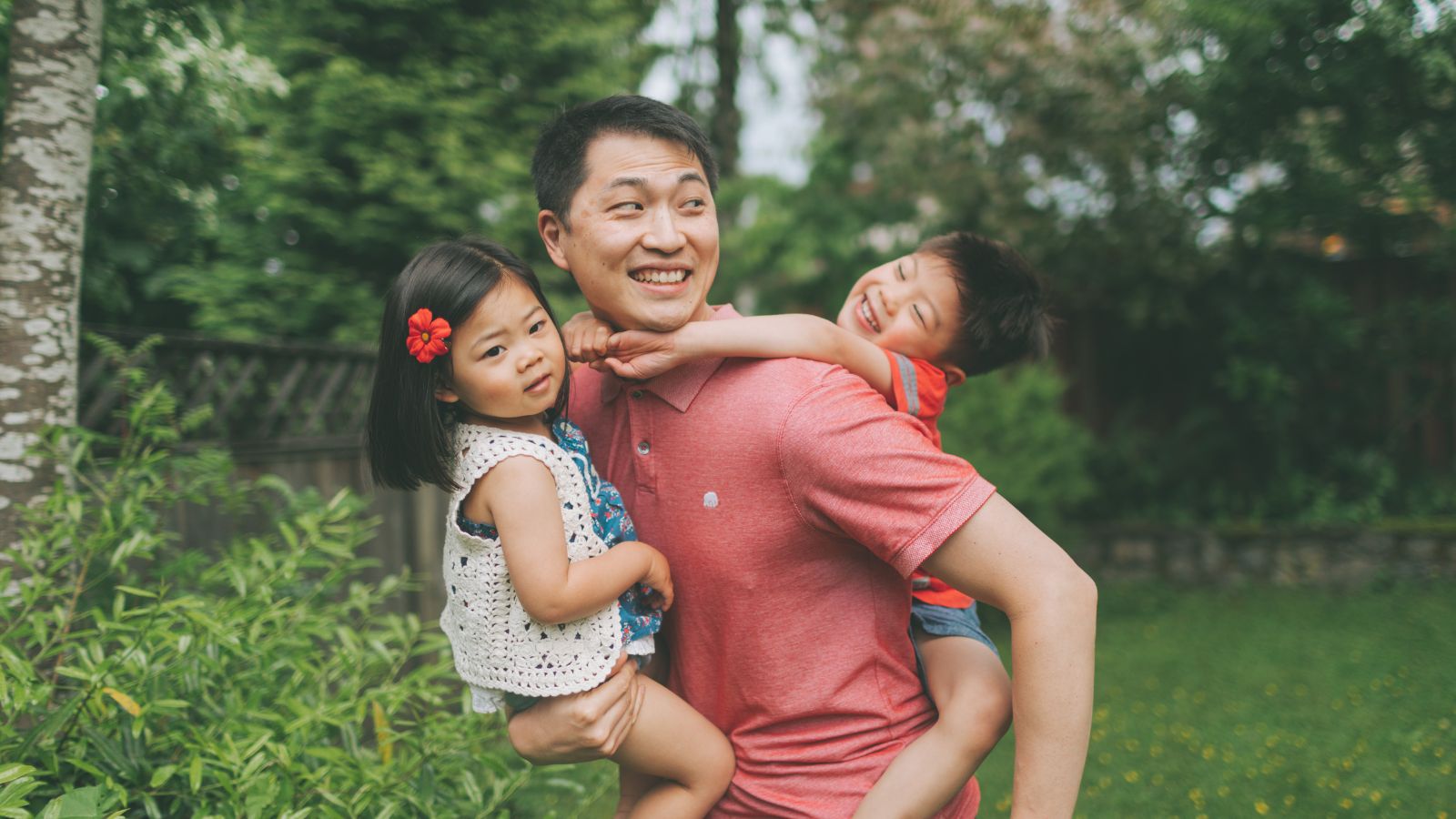 A confident dad in SilkCut boxer briefs and undershirt, relaxing comfortably at home with his kids.