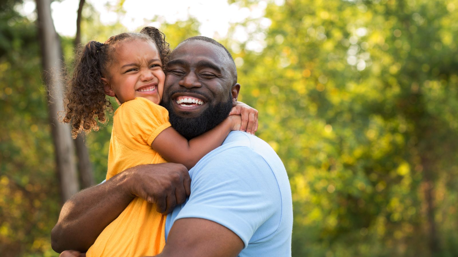 Father relaxing at home; dad wearing a SilkCut tee and boxer briefs, smiling with comfort and ease.
