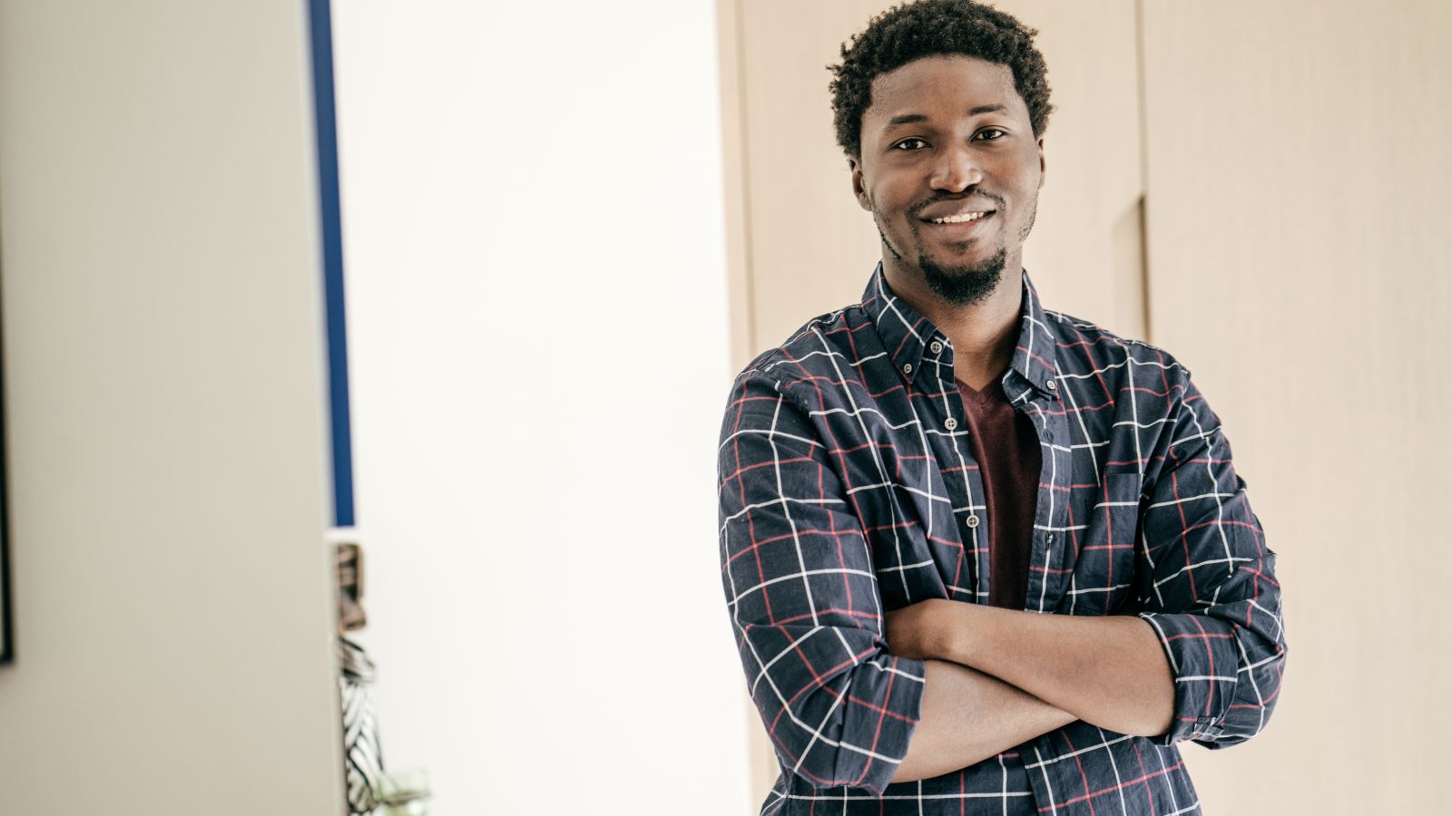 Man wearing breathable allergy-friendly boxer briefs and smiling in a sunlit room