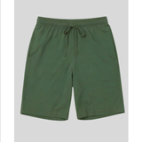 Green shorts with a drawstring on a light gray background