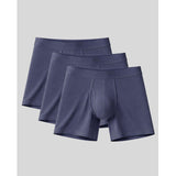 Three pairs of blue boxer briefs on a light gray background