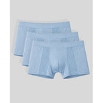 Three pairs of light blue boxer briefs on a gray background