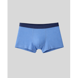 Blue boxer briefs with a dark blue waistband on a light gray background
