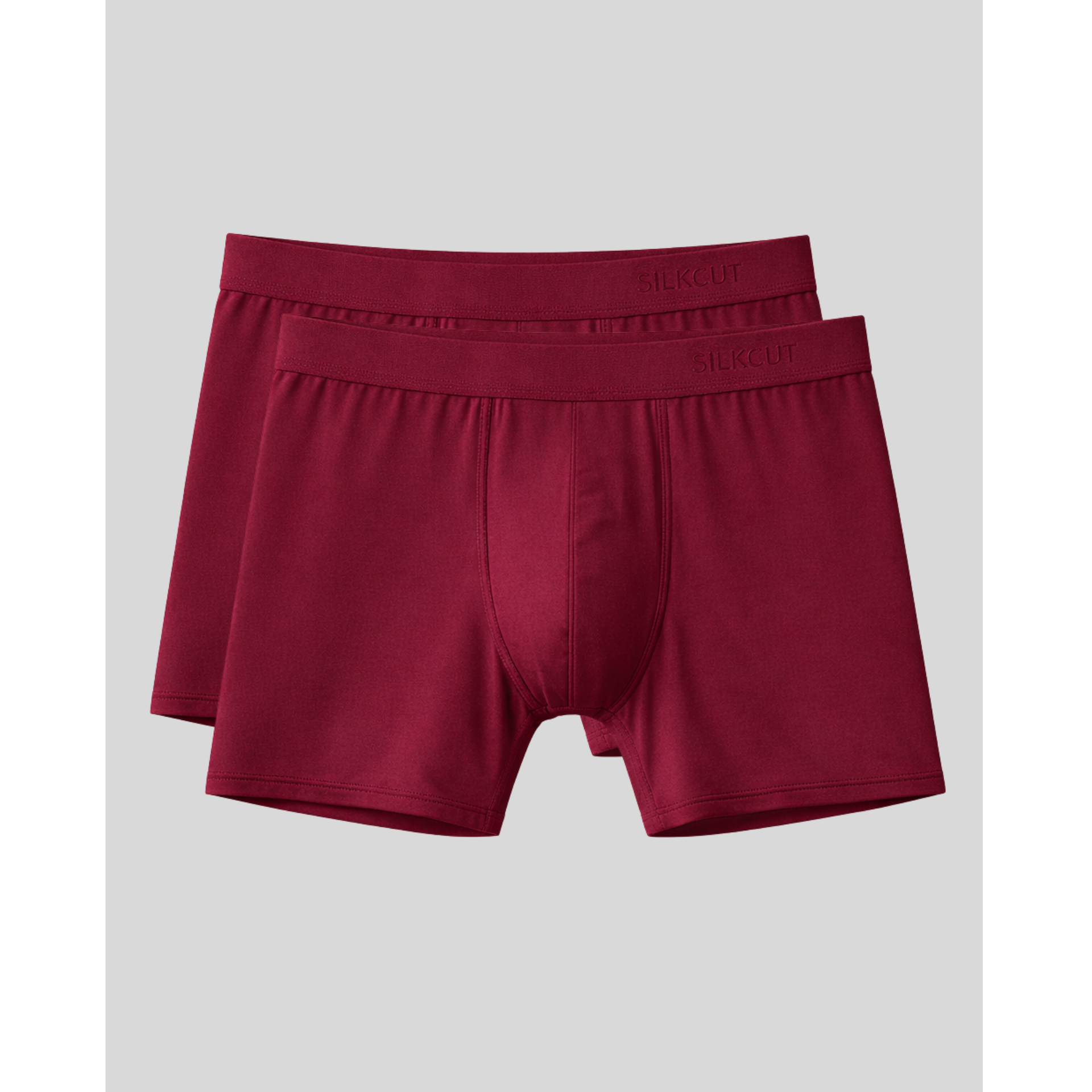 Two pairs of maroon performance boxer briefs on a light gray background
