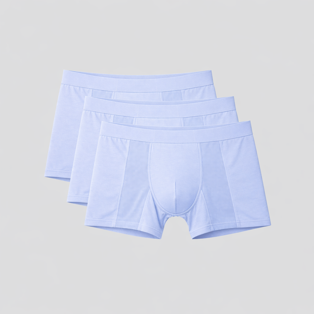 Three pairs of light blue boxer briefs on a gray background