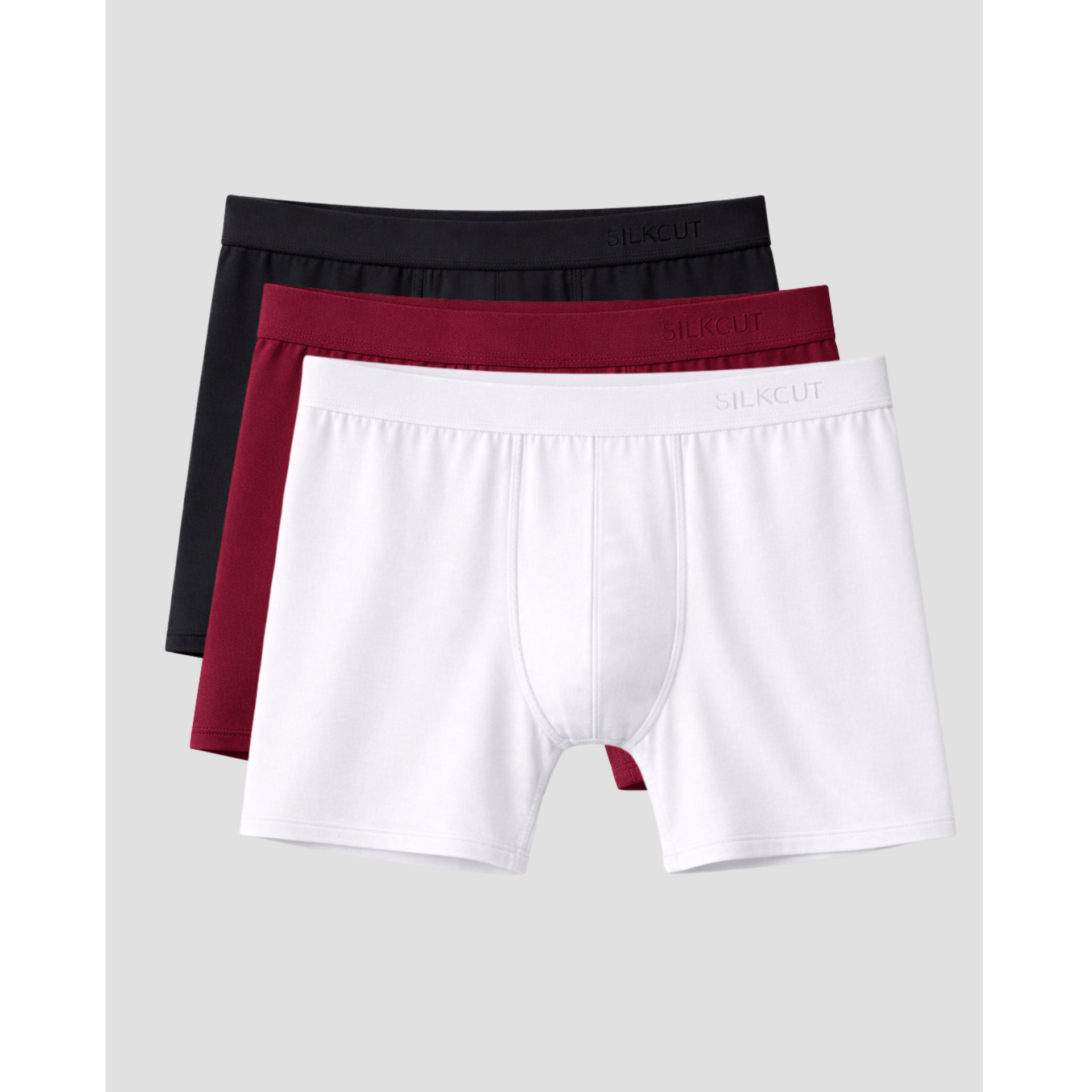 Three pairs of men's underwear in black, red, and white on a light gray background.