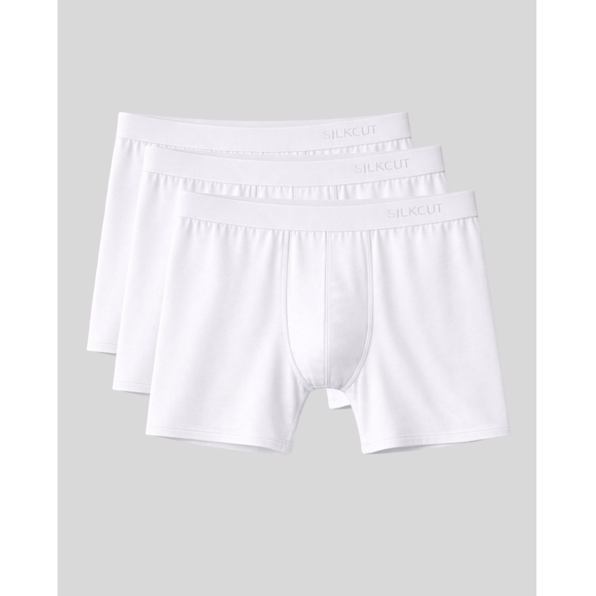Three pairs of white luxury boxer briefs stacked on a light gray background