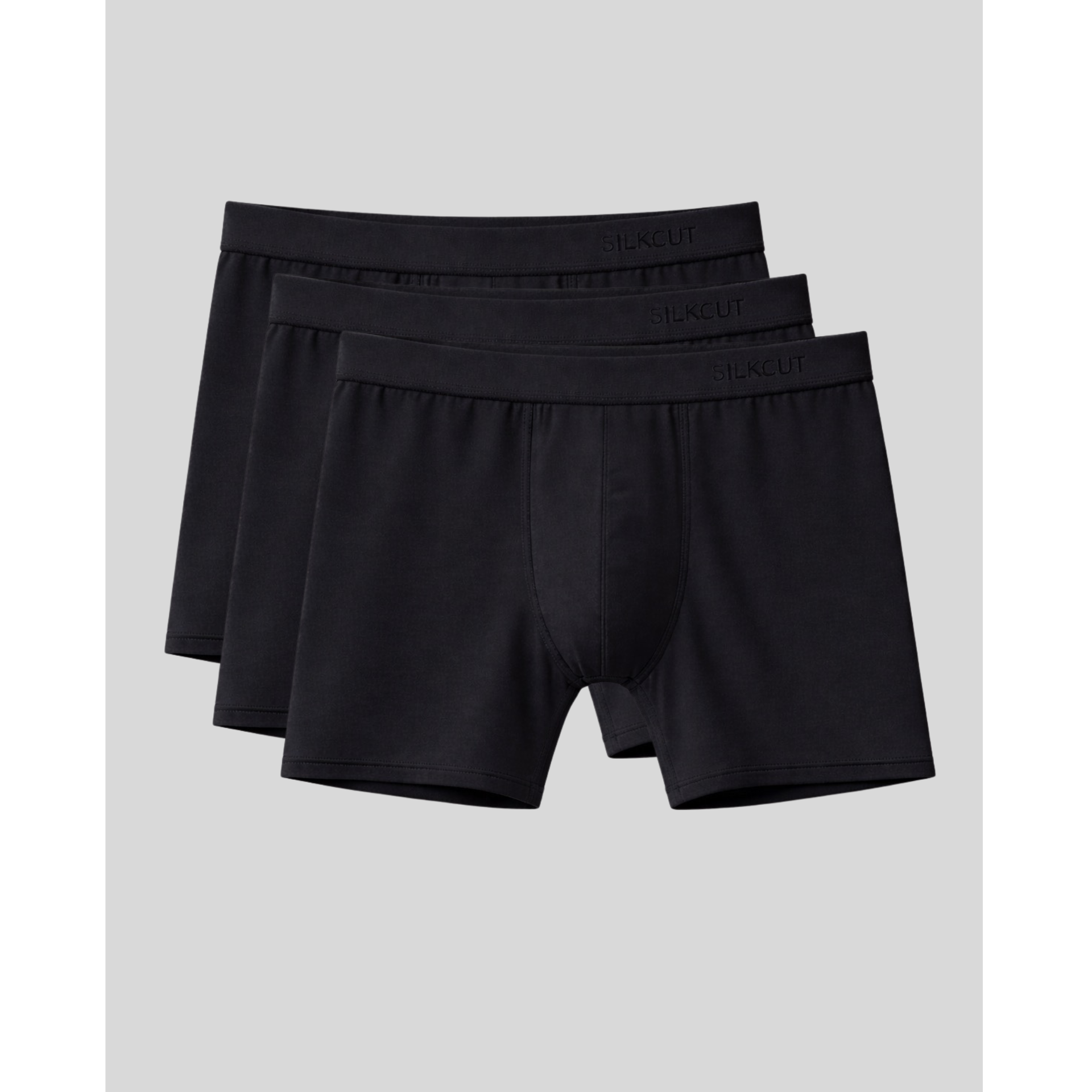 Three pairs of breathable black boxer briefs stacked on a light gray background