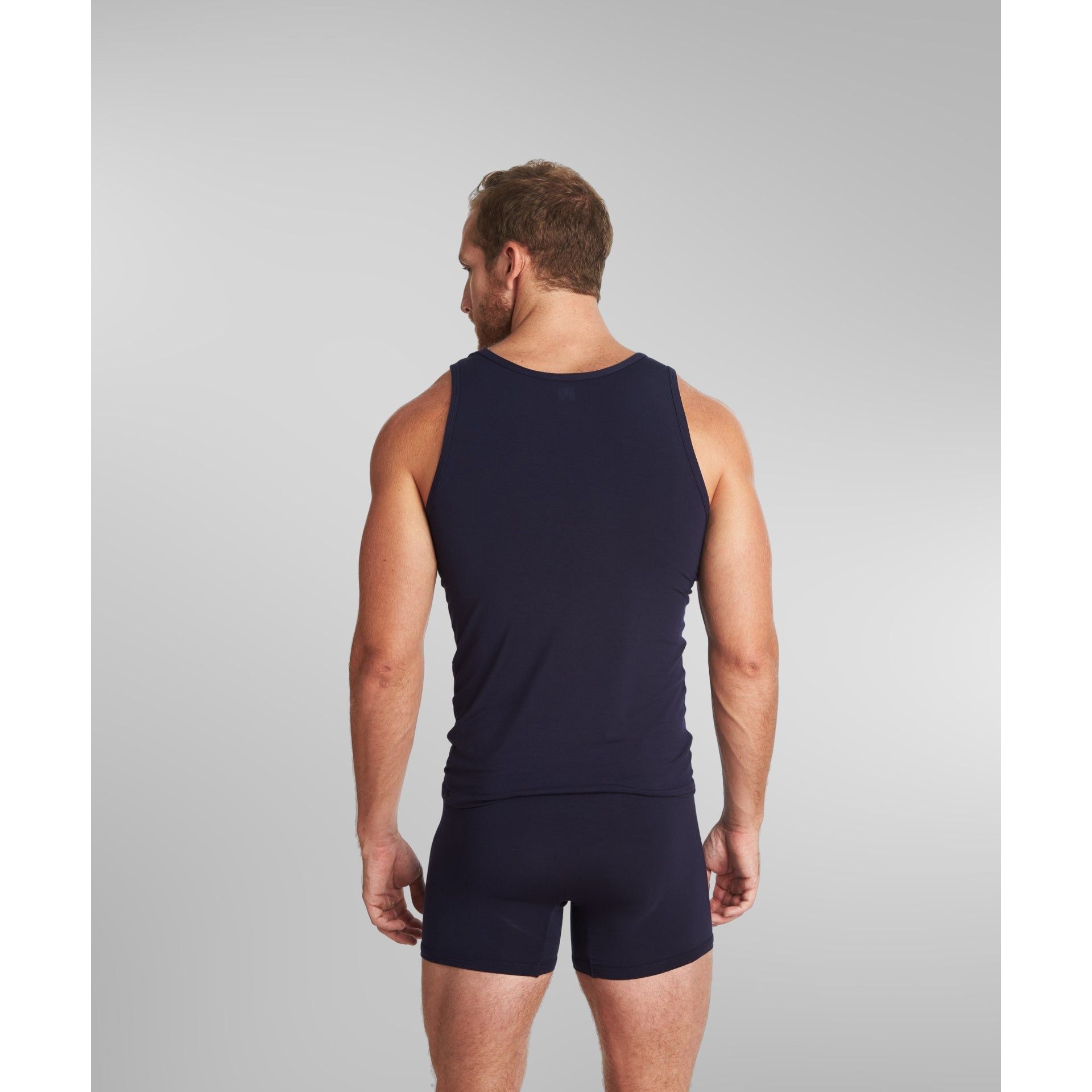 Model wearing SilkCut Micro Modal Air men’s tank top during workout, showing moisture-wicking performance and lightweight stretch fabric