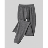 A pair of dark gray heathered silkcut thermal leggings for men pants with an elastic waistband and ribbed ankle cuffs, shown folded on a light gray background.