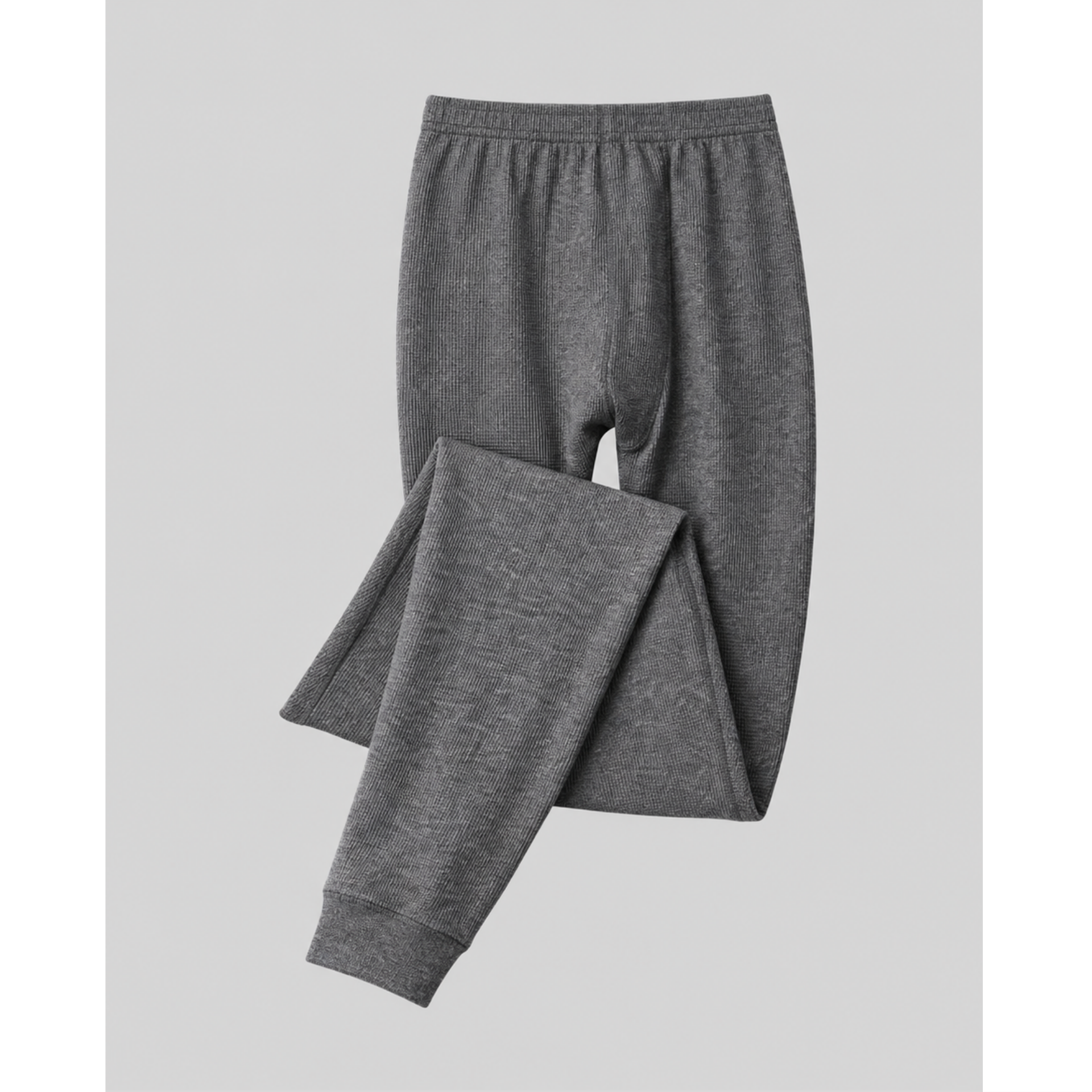 A pair of dark gray heathered silkcut thermal leggings for men pants with an elastic waistband and ribbed ankle cuffs, shown folded on a light gray background.