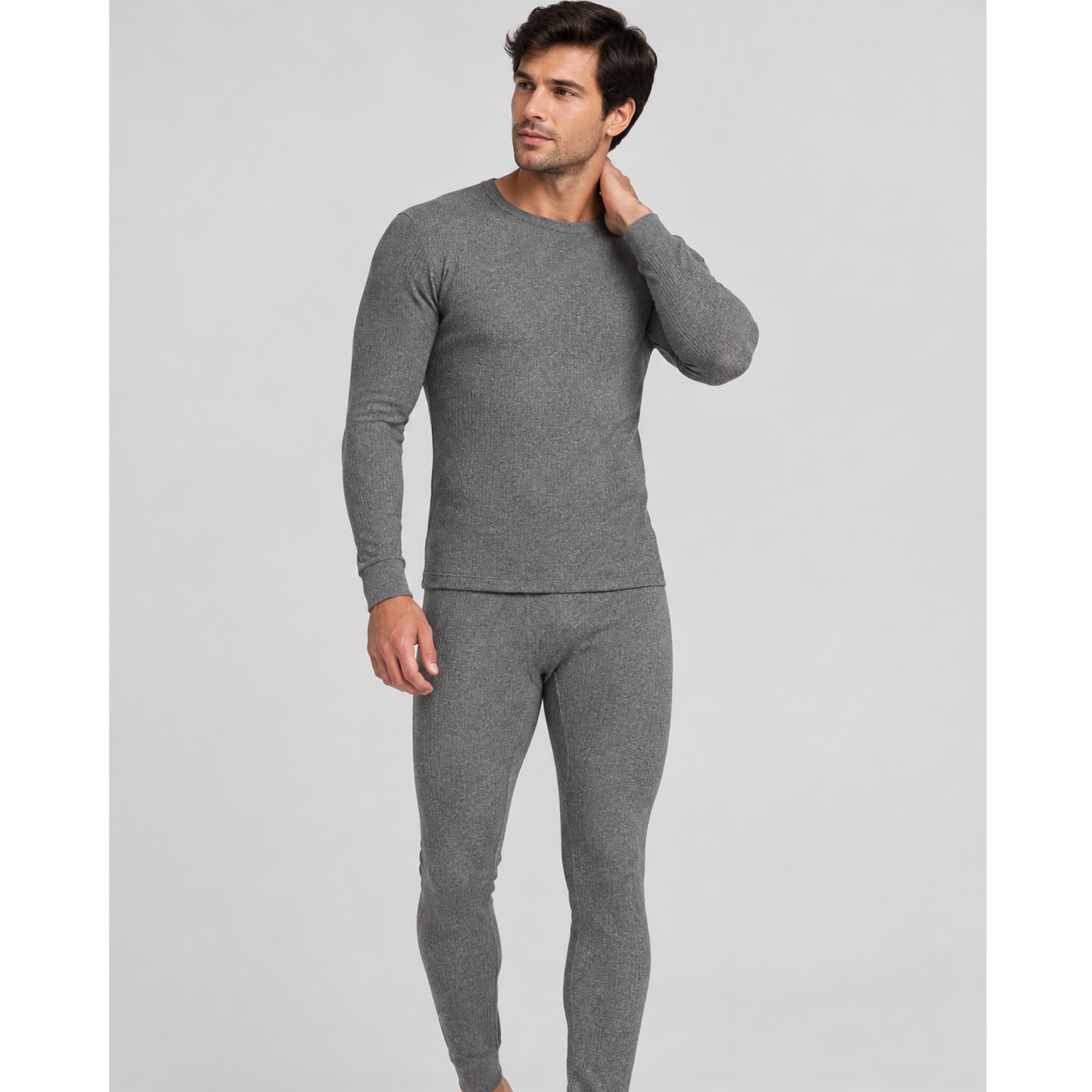 A man modeling a two-piece gray knit SilkCut Underwear thermal set consisting of a long-sleeve crewneck top and matching full-length pants, photographed against a solid light gray studio background.