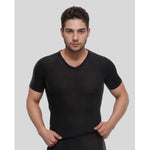 Man wearing a black t-shirt against a plain background