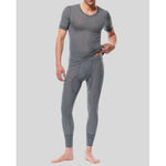 Man wearing gray thermal underwear on a plain background