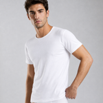 A man wearing a plain white micro modal air short-sleeve silkcut crew-neck t-shirt, photographed against a neutral light gray studio background.