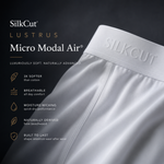 Close-up of a white SilkCut underwear micro modal air brief showing the waistband with embossed SILKCUT branding, set against a dark charcoal background with feature callouts for micro modal air fabric.