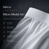 Close-up of a white SilkCut underwear micro modal air brief showing the waistband with embossed SILKCUT branding, set against a dark charcoal background with feature callouts for micro modal air fabric.