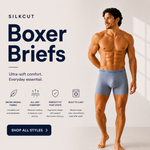 A male model stands barefoot wearing light blue SILKCut boxer briefs in a studio setting with promotional text on the left. The ad includes product benefits such as micro-modal fabric, all-day comfort, ergonomic support, and built-to-last comfort. silkcut underwear  micro modal air 