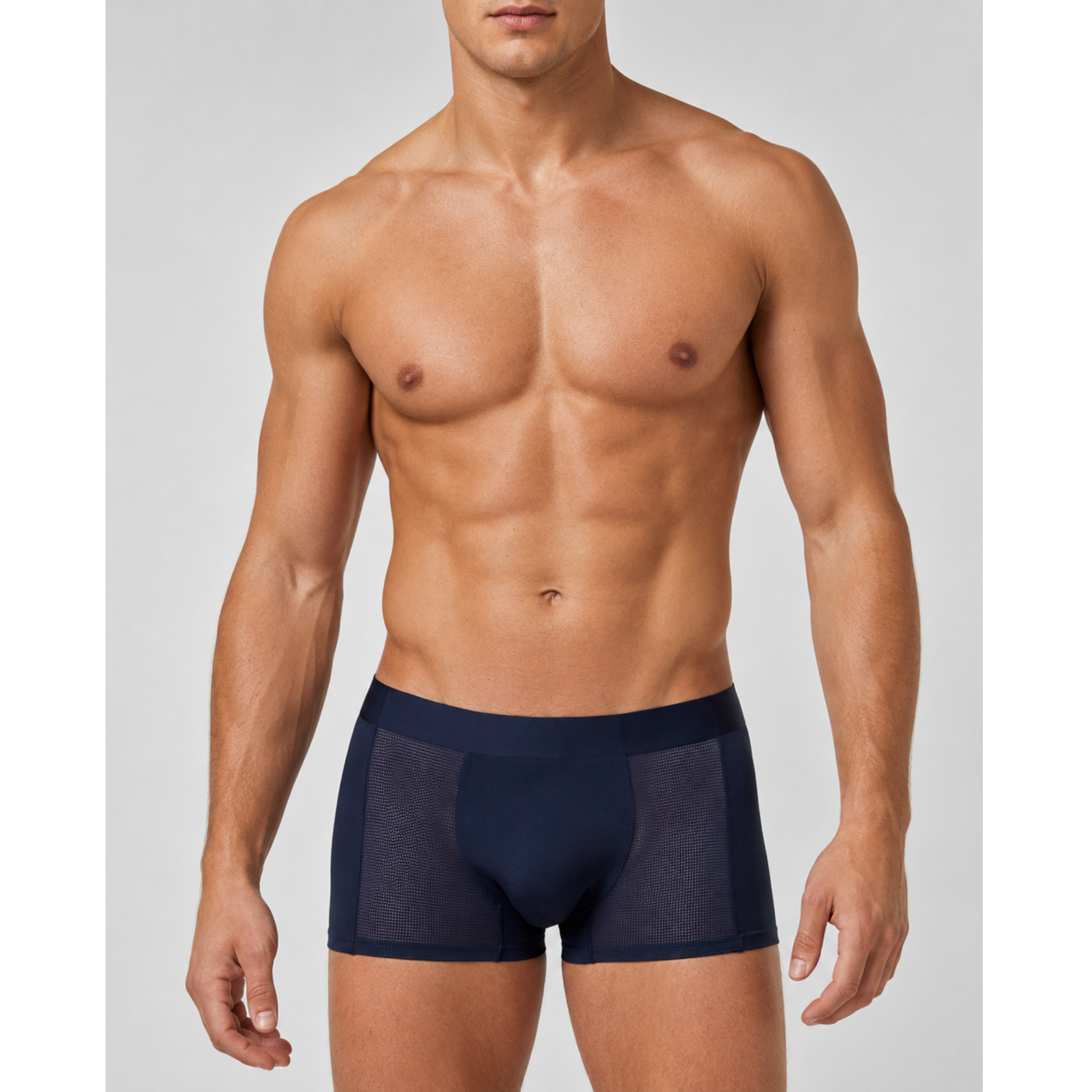 A shirtless male model wearing silkcut underwear  navy blue boxer briefs with sheer mesh side panels, photographed against a light gray studio background.