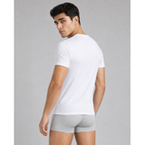 Male model wearing a white silkcut underwear  micro modal air men’s V-neck undershirt and grey boxer briefs in a front studio pose.